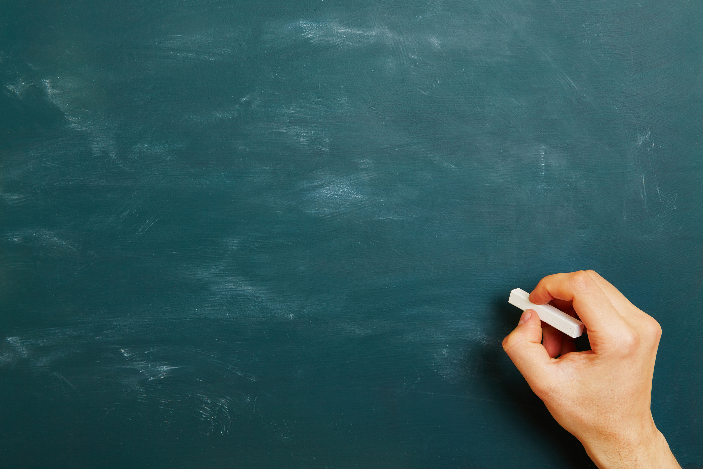 Hand Writing with Chalk on Chalkboard